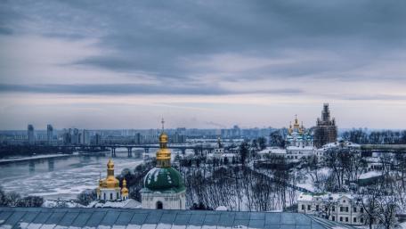 Serene Winter Cityscape with Golden Domes wallpaper