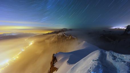 Majestic Mountain Nightscape with Star Trails wallpaper