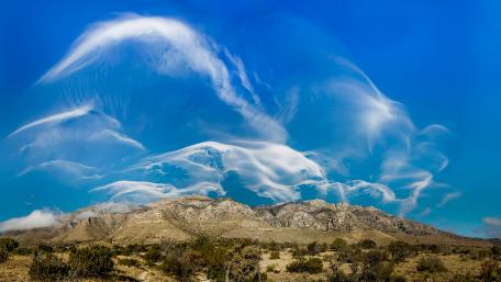 Majestic Clouds Over Serene Mountains wallpaper