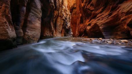 Majestic River Flowing Through Narrow Canyon Walls wallpaper
