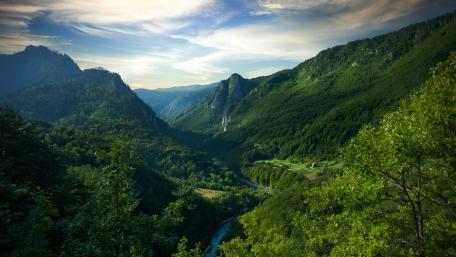 Serene Mountain Landscape with Lush Valleys and Clear Sky wallpaper