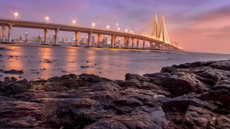 Majestic Bridge Glowing Under Sunset Sky wallpaper