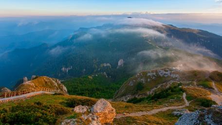 Majestic Mountain Vista Amidst Dreamy Clouds wallpaper