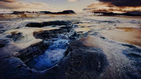 Majestic geothermal landscape with steam rising from the earth's surface. wallpaper