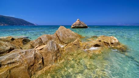 Serene Coastal Beauty Under Clear Blue Skies wallpaper