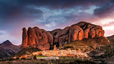 Majestic Sunset Over Serene Mountain Village wallpaper
