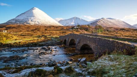 Majestic Mountain Landscape with Historic Stone Bridge wallpaper