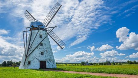 Windmill in a Serene Landscape of Nature Tapestry wallpaper