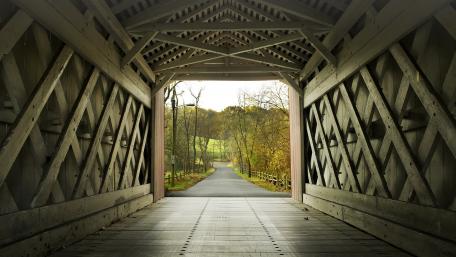 Tranquil Pathway through a Historic Covered Bridge wallpaper