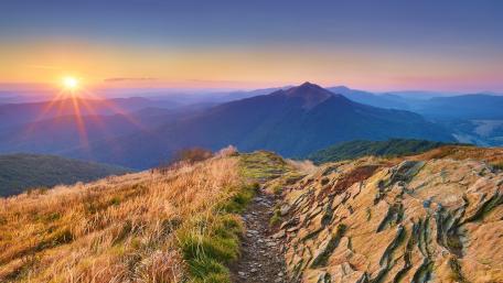 Majestic Sunrise Over Mountain Peaks wallpaper