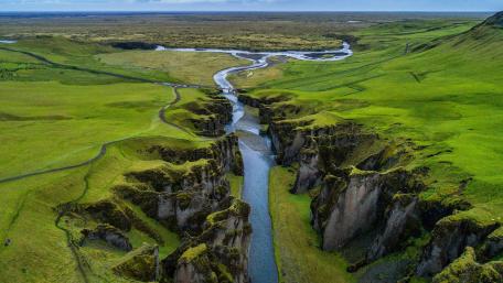 Majestic Canyon Landscape in Iceland with Lush Greenery and Flowing River wallpaper