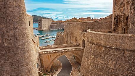 Ancient Walls Overlooking a Coastal Harbor wallpaper
