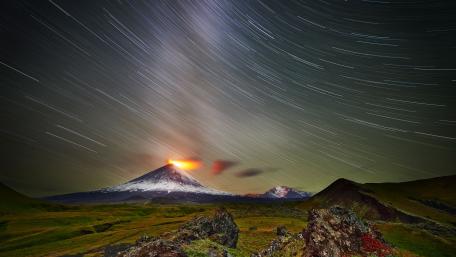 Majestic Eruption Under Starry Skies wallpaper