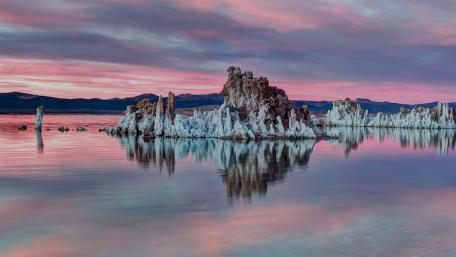 Serene Tufa Formations Under Colorful Sunset Sky wallpaper