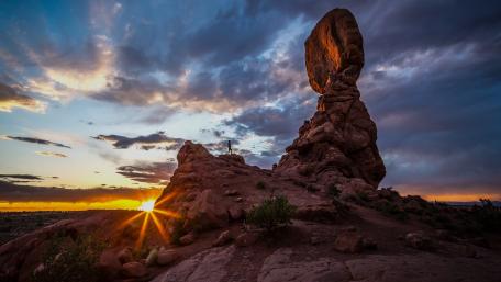 Majestic Sunset Over Towering Rock Formation wallpaper