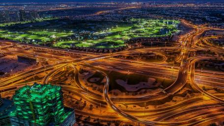 Glowing Cityscape at Night Above the Urban Jungle wallpaper