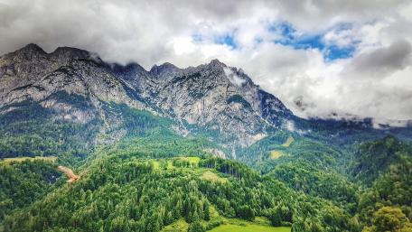 Majestic Mountains Surrounded by Lush Greenery wallpaper