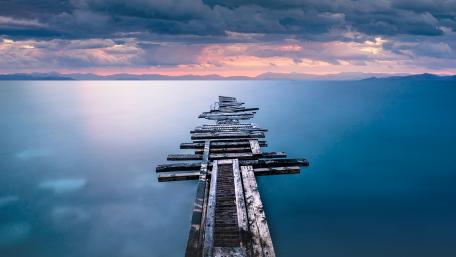 Serenity of an Abandoned Pier Overlooking Calm Waters wallpaper