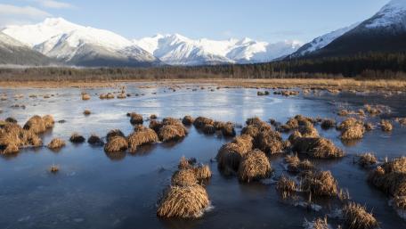 Serene Winter Landscape with Mountains and Frozen Lake wallpaper