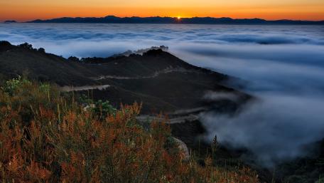 Serene Sunrise Over Misty Mountains wallpaper