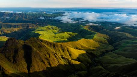 Majestic Rolling Hills Under a Vibrant Sky wallpaper