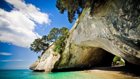 Serene Coastal Cave with Vibrant Waters wallpaper