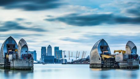 Serene Cityscape at Dawn Over Waterway wallpaper
