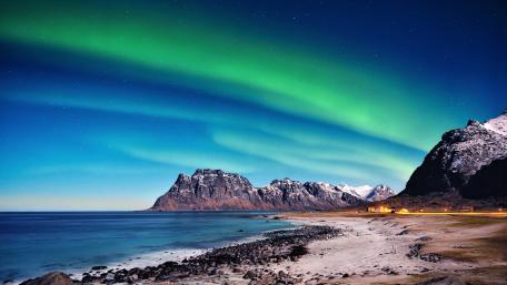 Breathtaking Northern Lights Over Majestic Landscape wallpaper