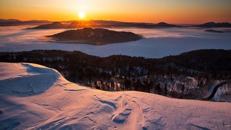 Serene Sunrise Over Snowy Landscape wallpaper