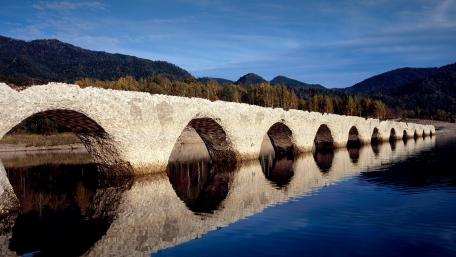 Serene Reflection of Nature's Archway wallpaper