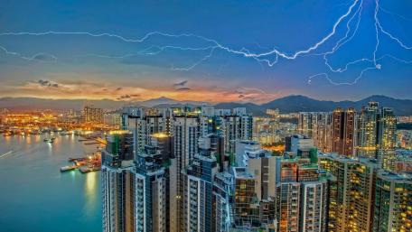 Stunning City Skyline Illuminated by Lightning Storm wallpaper