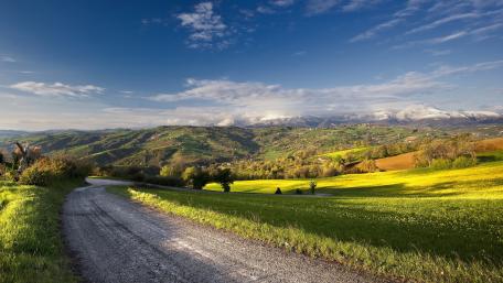 Serene Landscape of Rolling Hills and Mountains wallpaper
