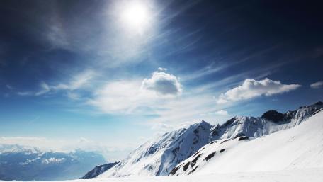 Majestic Snow-Capped Mountains Under Brilliant Blue Sky wallpaper