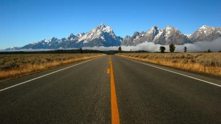 Majestic Roadway to Serene Mountains wallpaper