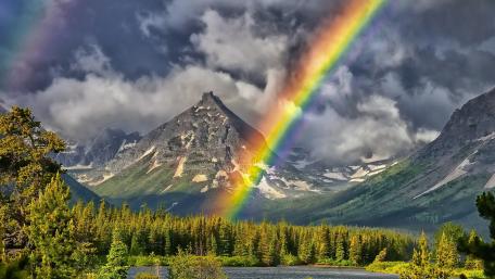 Majestic Rainbow Over Serene Mountains and Forests wallpaper