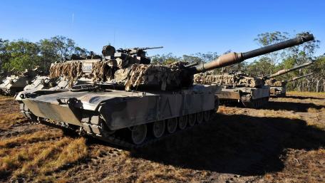 Powerful Tanks in a Military Landscape Scene wallpaper