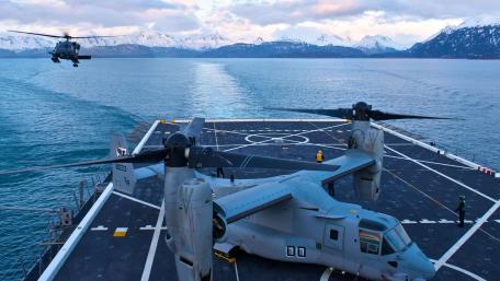 Military Aircraft in Action Over Scenic Waterscape wallpaper