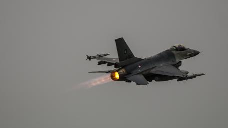 Dynamic Fighter Jet in Action Amidst Cloudy Skies wallpaper