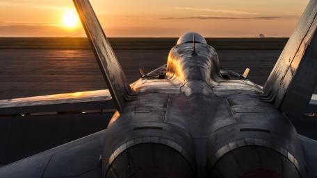 Jet Fighter at Sunrise Over Airfield wallpaper