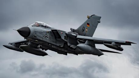 Fighter Jet in Action Above the Clouds wallpaper