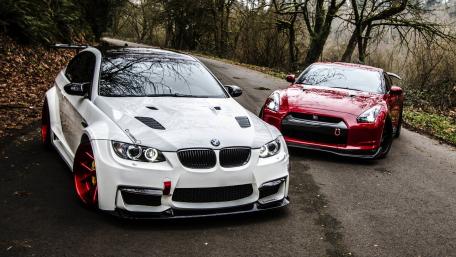 Stylish Sports Cars on a Scenic Roadway wallpaper