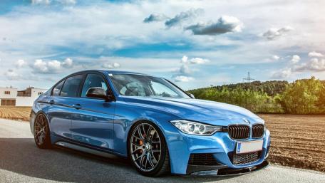 Sleek Blue BMW on Open Road wallpaper