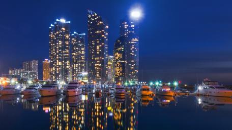 Vibrant Cityscape at Night with Reflections in Water wallpaper