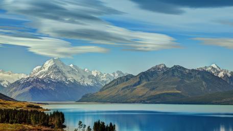 Serene Mountain Landscape with Reflective Waters wallpaper