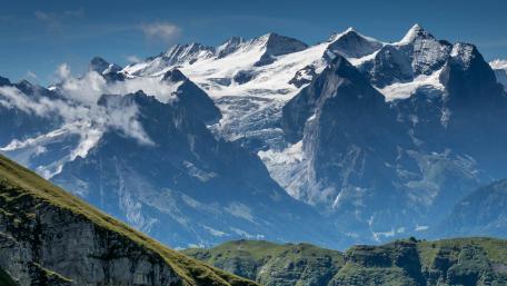 Majestic Mountain Range Under Clear Blue Sky wallpaper