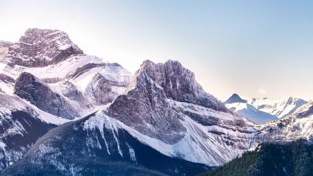 Majestic Snow-Capped Mountains Under a Clear Sky wallpaper