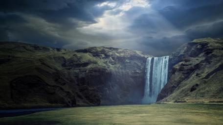 Majestic Waterfall Under Dramatic Skies wallpaper