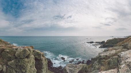 Serene Coastal View with Waves and Clouds wallpaper