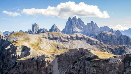 Majestic Mountain Peaks Under Vibrant Blue Sky wallpaper
