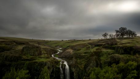 Serene Waterfall Amidst Lush Greenery wallpaper